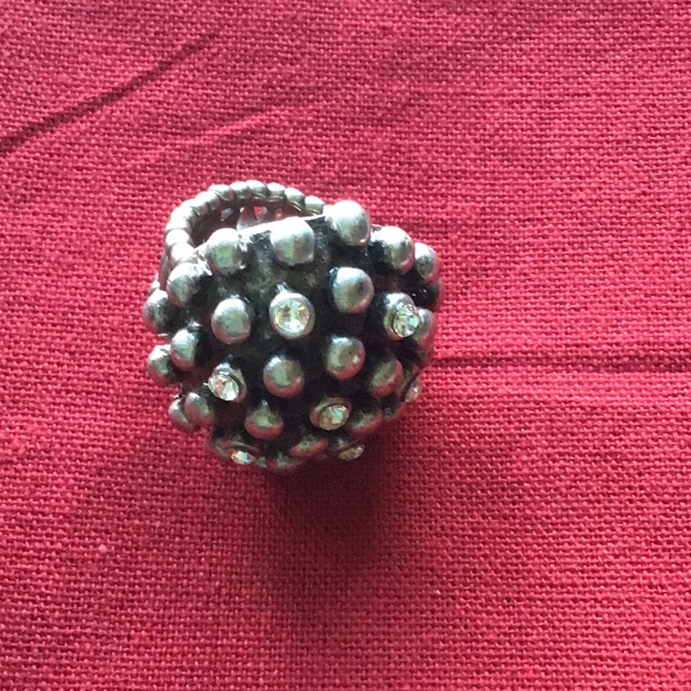 Silver tone ring. Stretchy. Will fit size 7 and up.